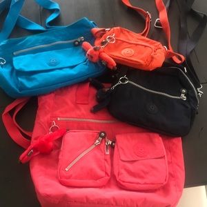 4 Kipling bags with key chains.